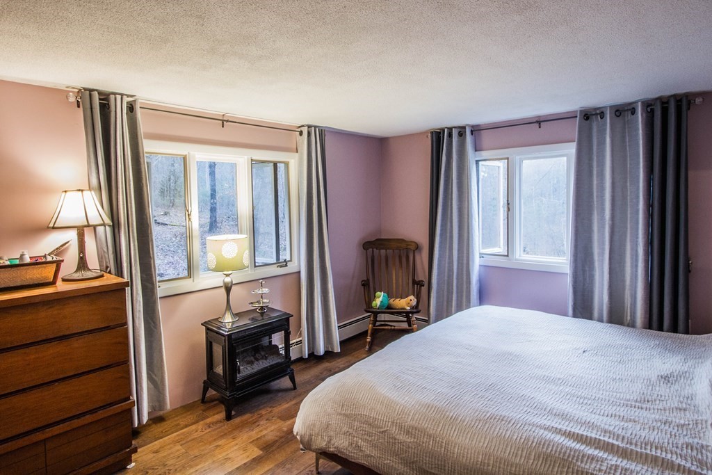 116 Oakham Road Barre, MA 01005 - Photo 10 of 21 a bedroom with a bed and wooden floor