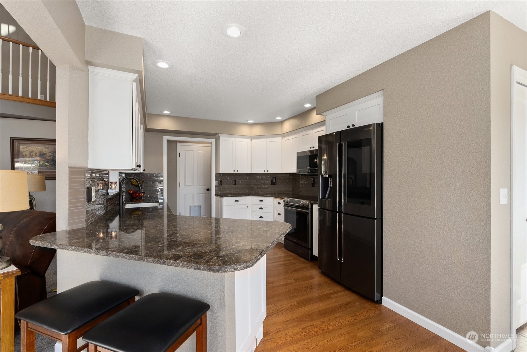 10909 188th Avenue Southwest Rochester, WA 98579 - Photo 15 of 40 a kitchen with stainless steel appliances granite countertop a refrigerator a stove and a sink