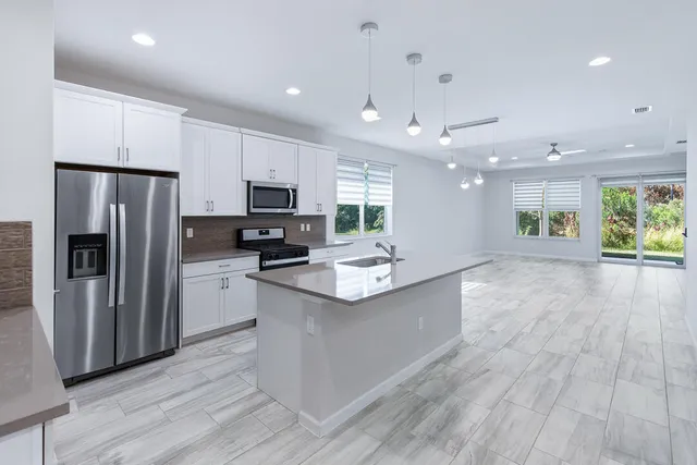 a bathroom with a granite countertop sink tub and shower