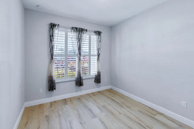 a workspace with furniture window and wooden floor
