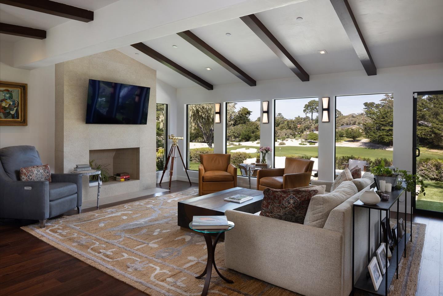 2931 Sloat Road Pebble Beach, CA 93953 - Photo 3 of 34 a living room with fireplace furniture and a flat screen tv