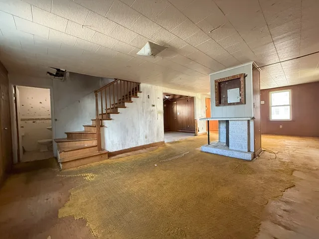 a view of empty room with a fireplace and cabinet