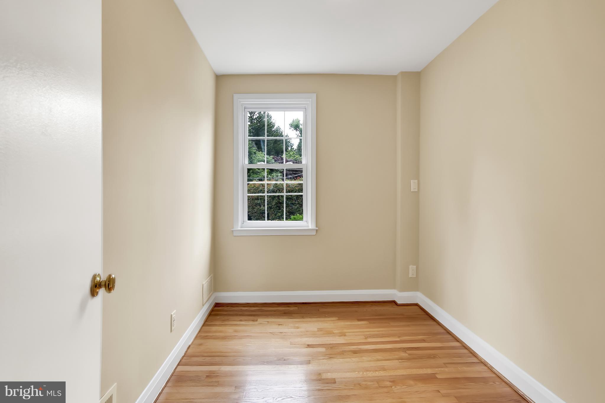 7134 Heathfield Road Baltimore, MD 21212 - Photo 12 of 28 a view of an empty room with wooden floor and a window