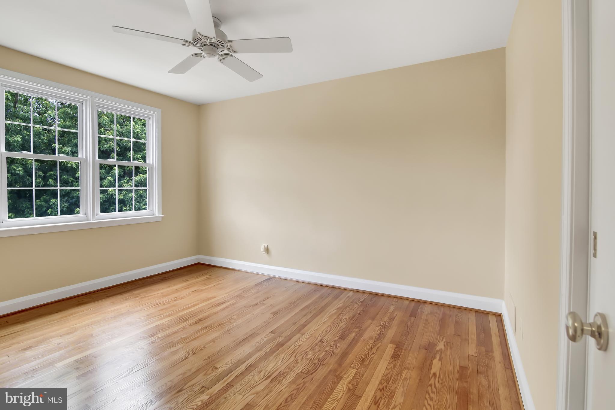 7134 Heathfield Road Baltimore, MD 21212 - Photo 14 of 28 an empty room with a window and wooden floor