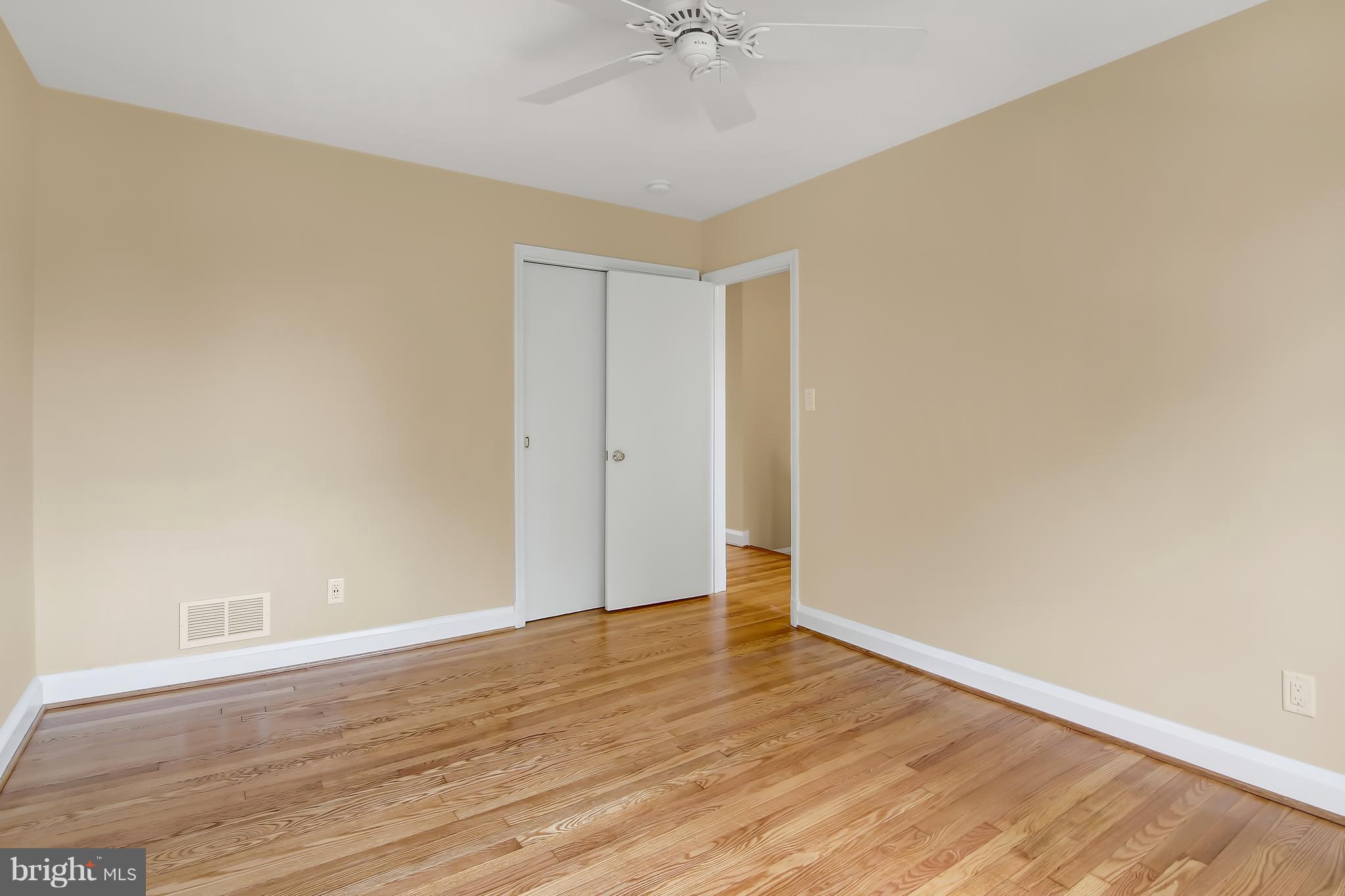 7134 Heathfield Road Baltimore, MD 21212 - Photo 15 of 28 a view of an empty room with wooden floor