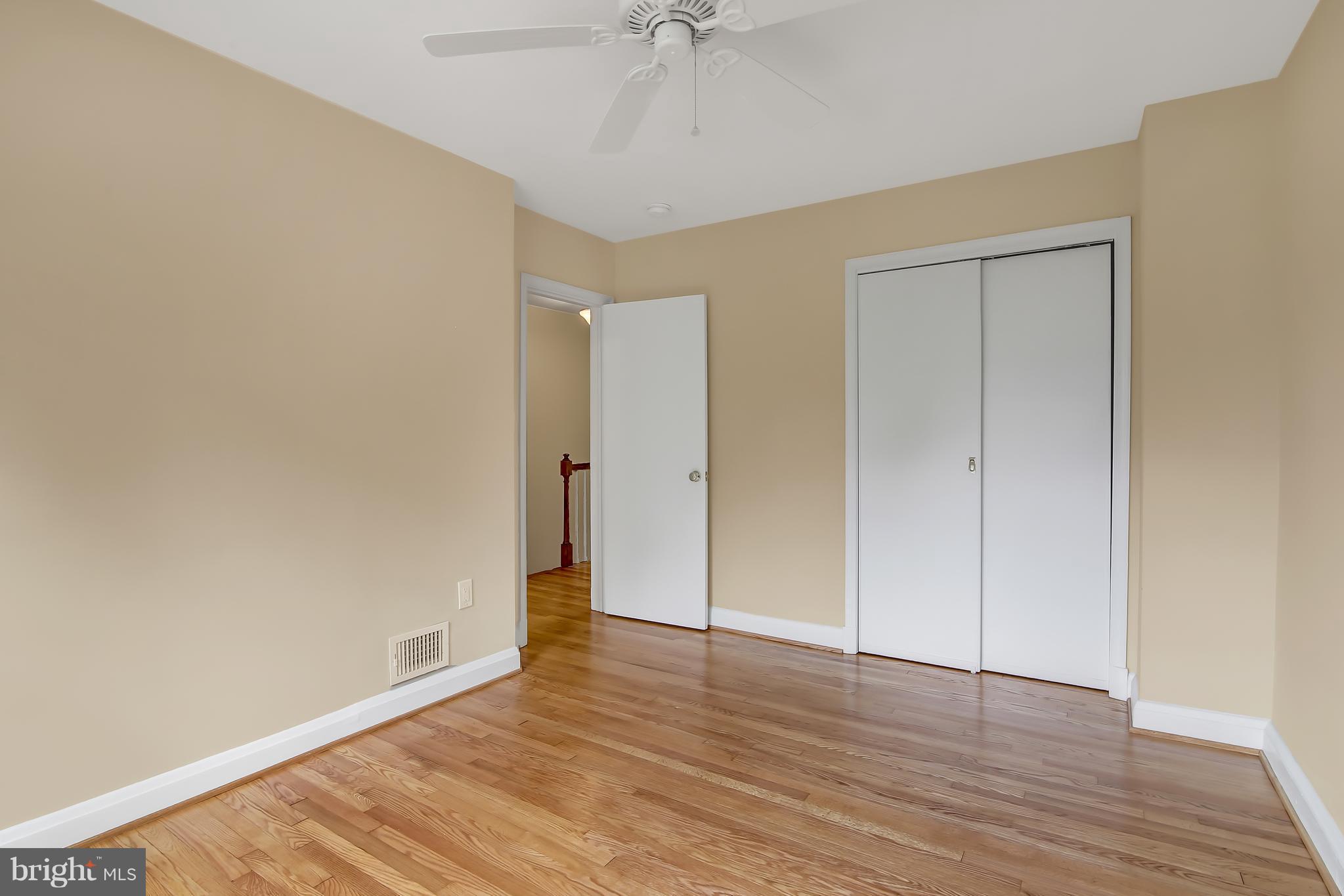 7134 Heathfield Road Baltimore, MD 21212 - Photo 18 of 28 a view of an empty room with wooden floor
