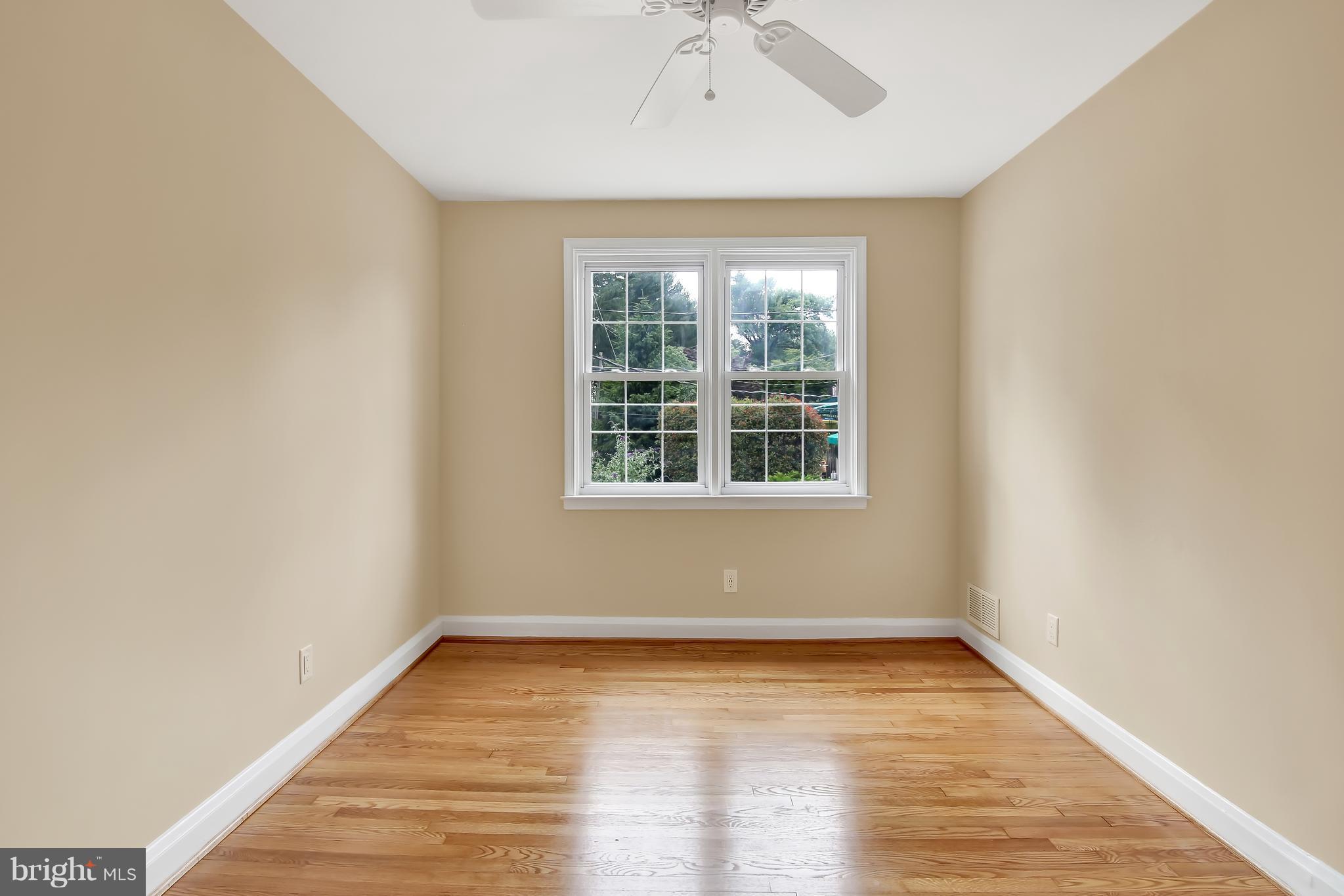 7134 Heathfield Road Baltimore, MD 21212 - Photo 19 of 28 an empty room with wooden floor and windows
