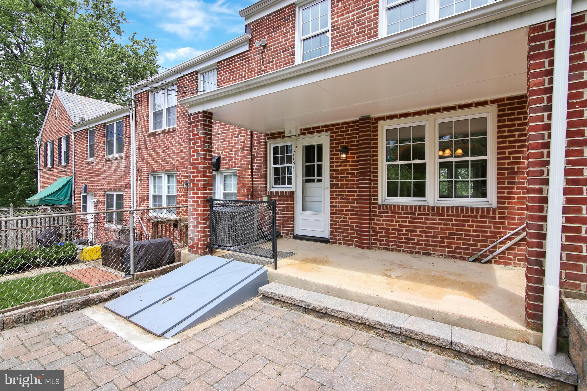 7134 Heathfield Road Baltimore, MD 21212 - Photo 26 of 28 a view of a house with a large window and wooden fence