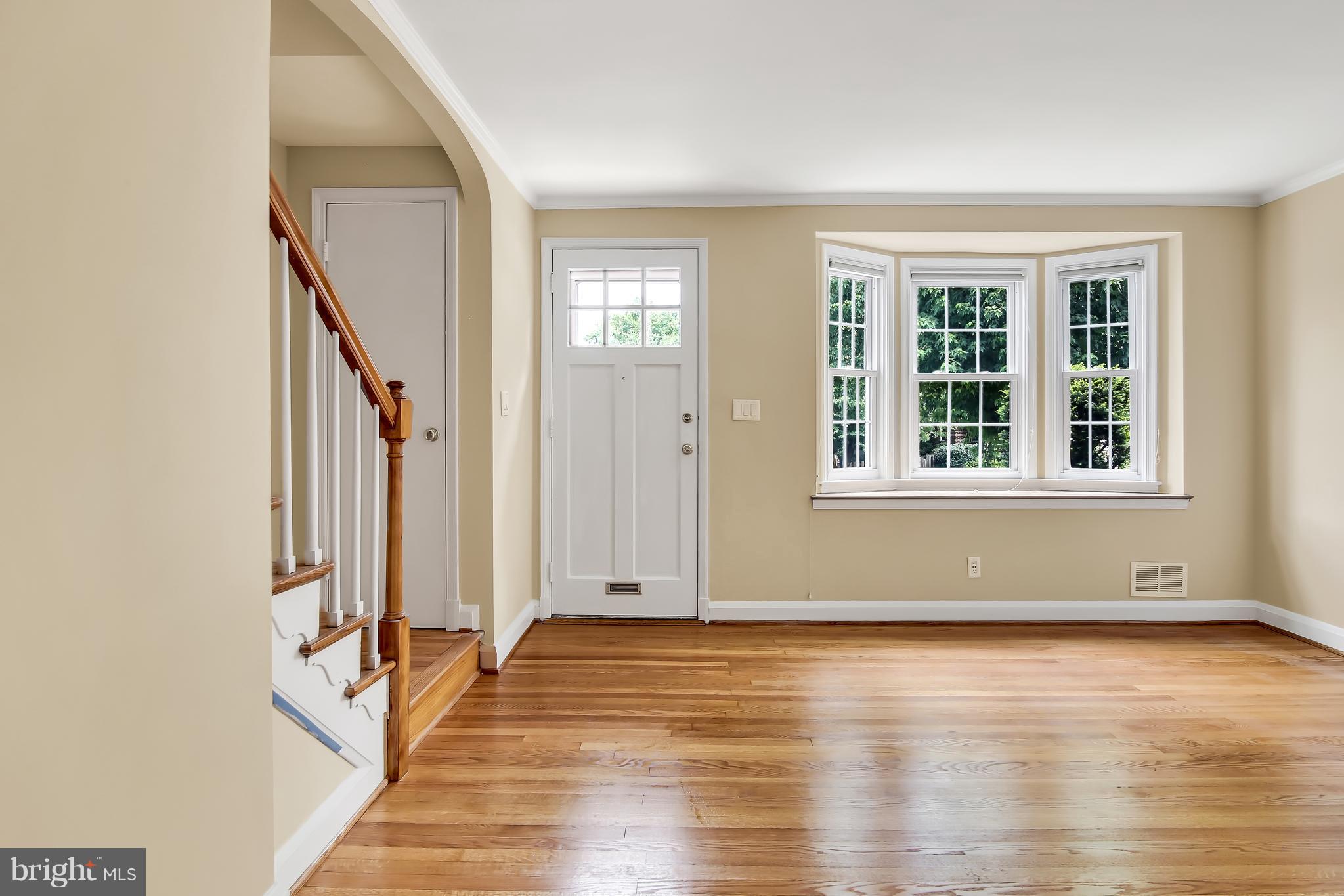 7134 Heathfield Road Baltimore, MD 21212 - Photo 4 of 28 an empty room with wooden floor and windows