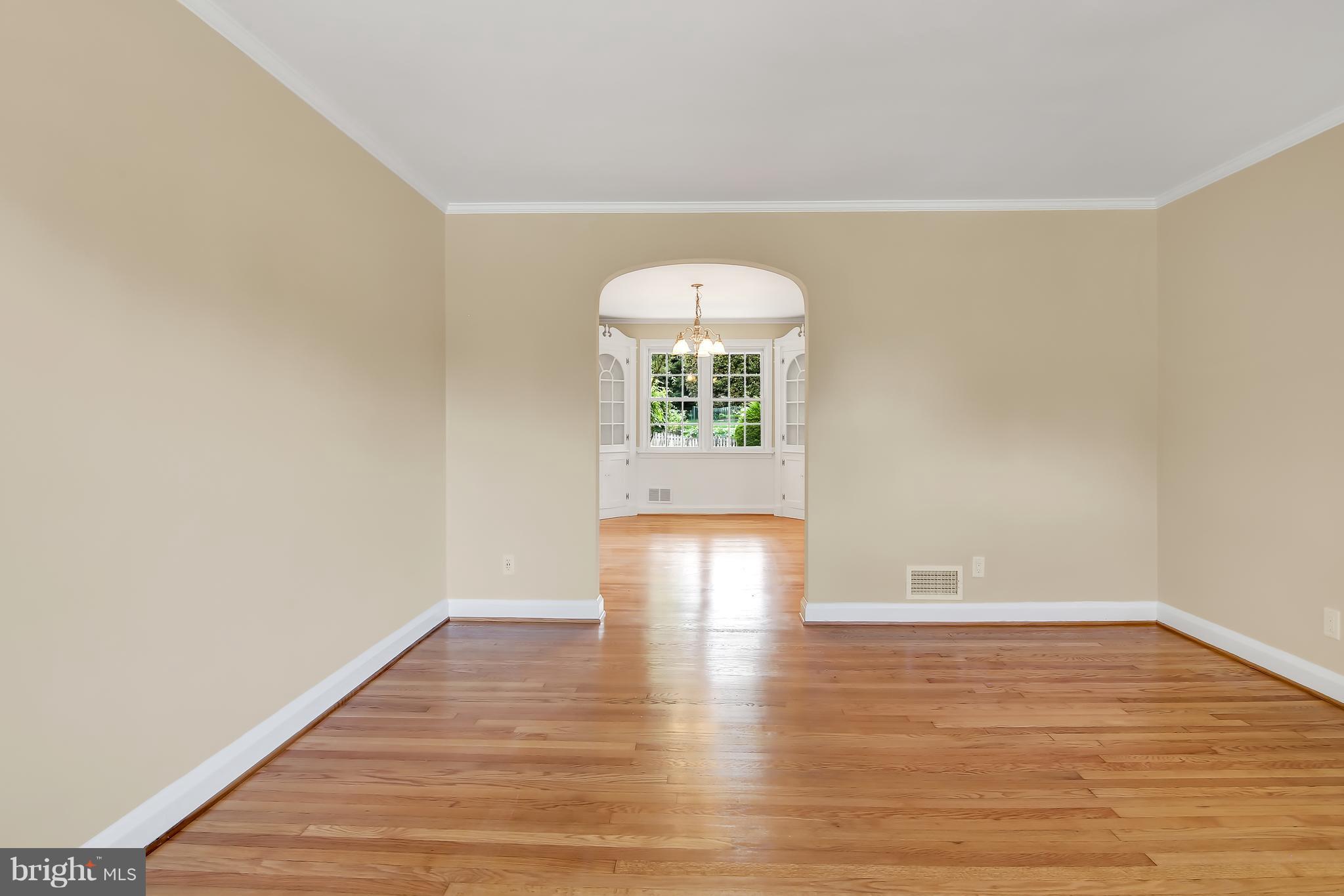 7134 Heathfield Road Baltimore, MD 21212 - Photo 6 of 28 a view of an empty room with wooden floor and a window