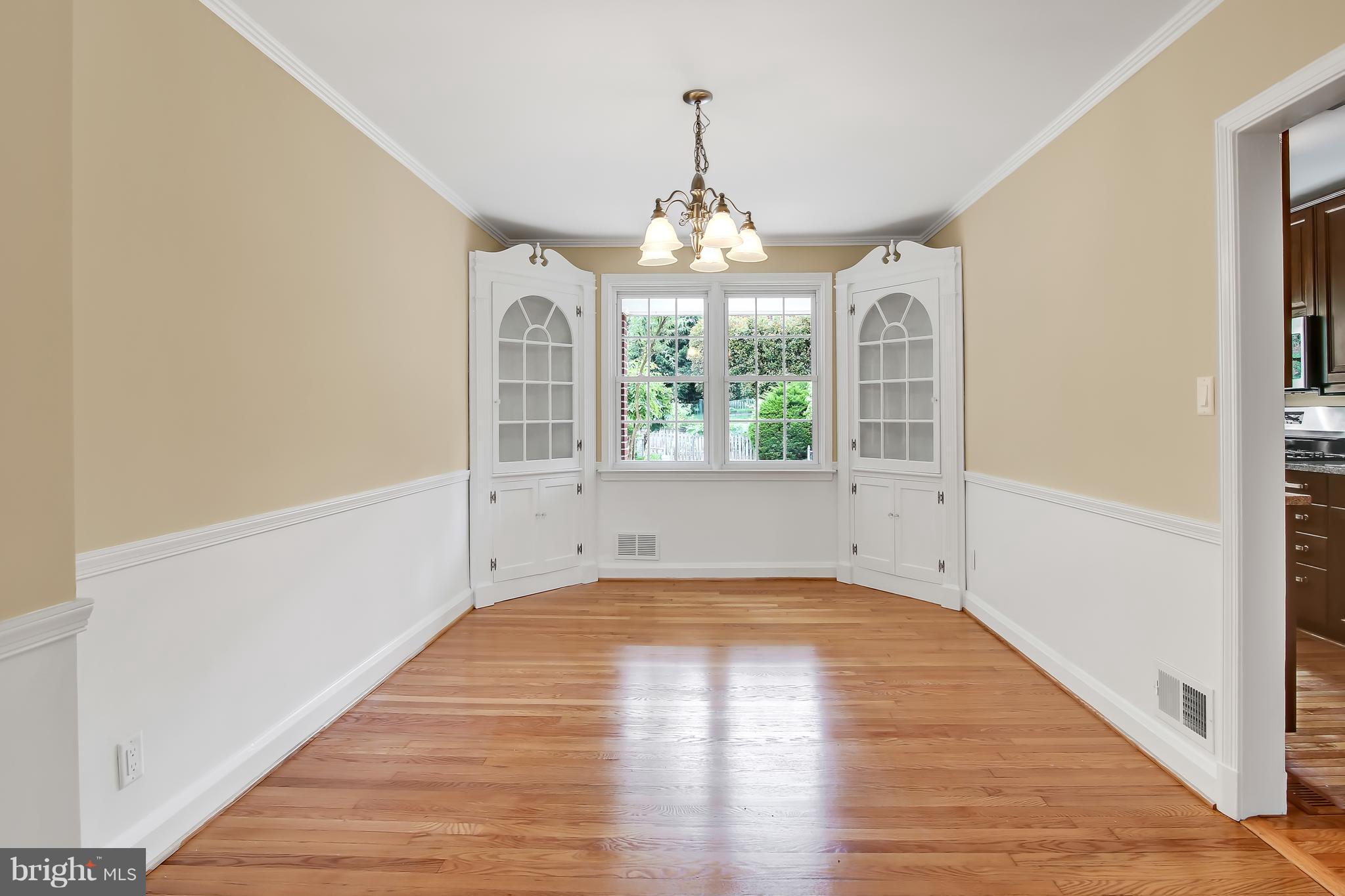 7134 Heathfield Road Baltimore, MD 21212 - Photo 7 of 28 a view of an empty room with wooden floor and a window