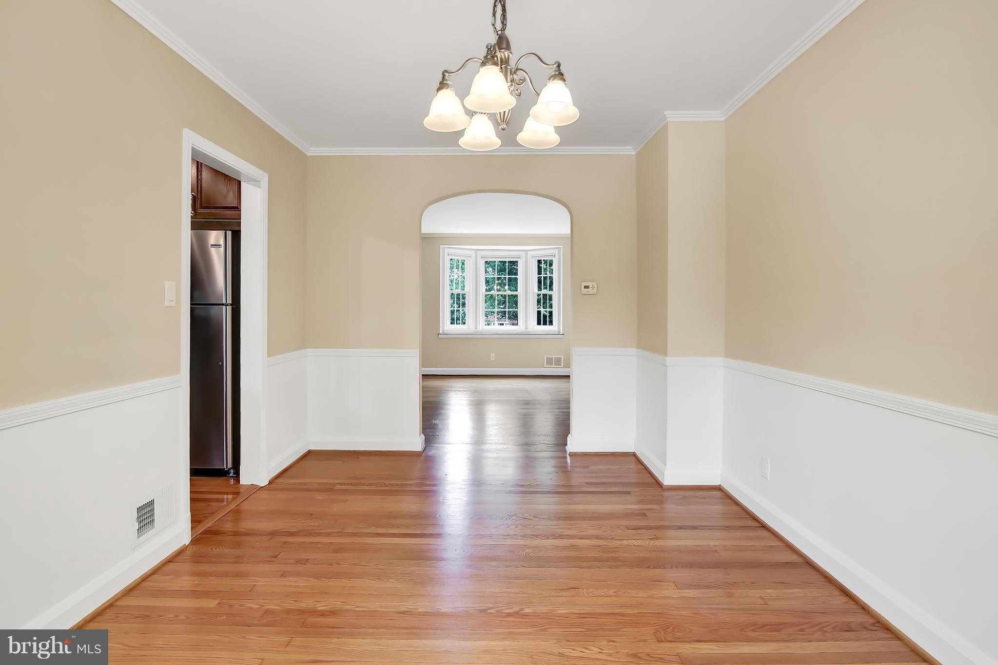 7134 Heathfield Road Baltimore, MD 21212 - Photo 8 of 28 a view of an empty room with wooden floor and a window