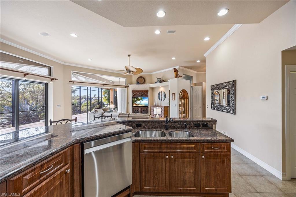 146 Windward Cay Naples, FL 34114 - Photo 12 of 33 a kitchen with stainless steel appliances granite countertop a sink and a stove