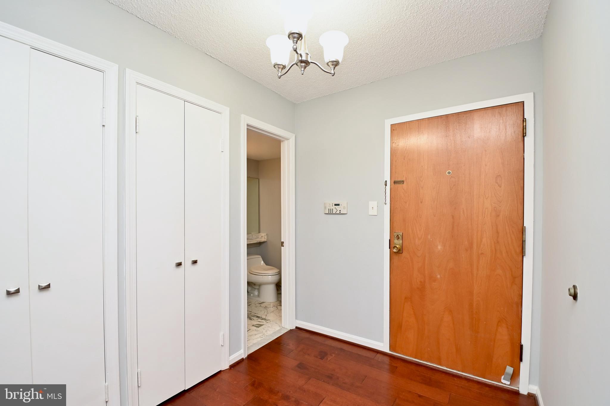 1101 South Arlington Ridge Road, Unit 509 Arlington, VA 22202 - Photo 11 of 62 an empty room with wooden floor chandelier fan and closet area