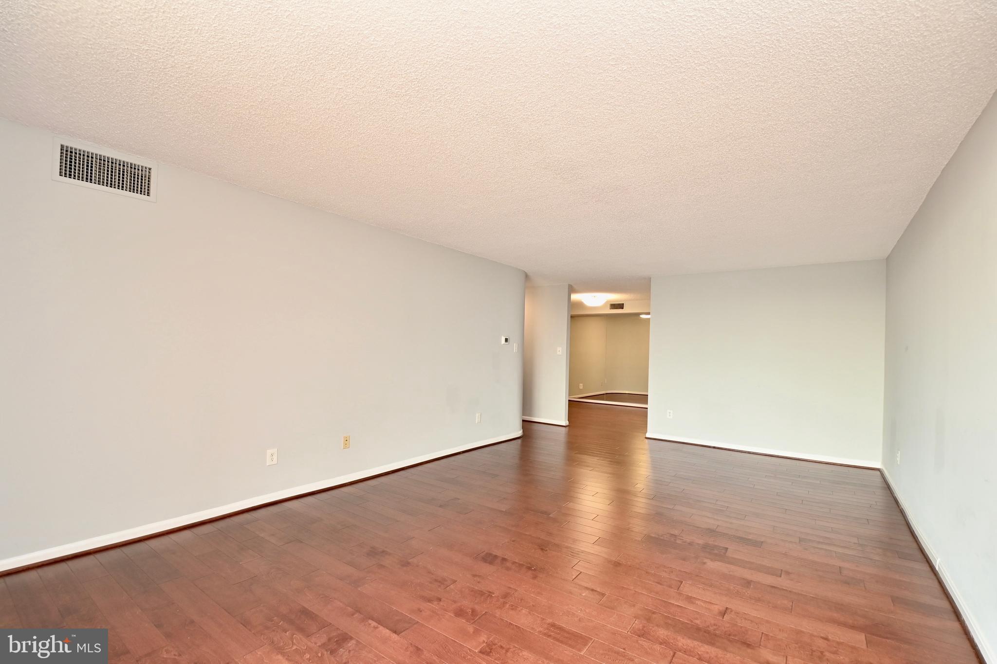 1101 South Arlington Ridge Road, Unit 509 Arlington, VA 22202 - Photo 15 of 62 an empty room with wooden floor and windows