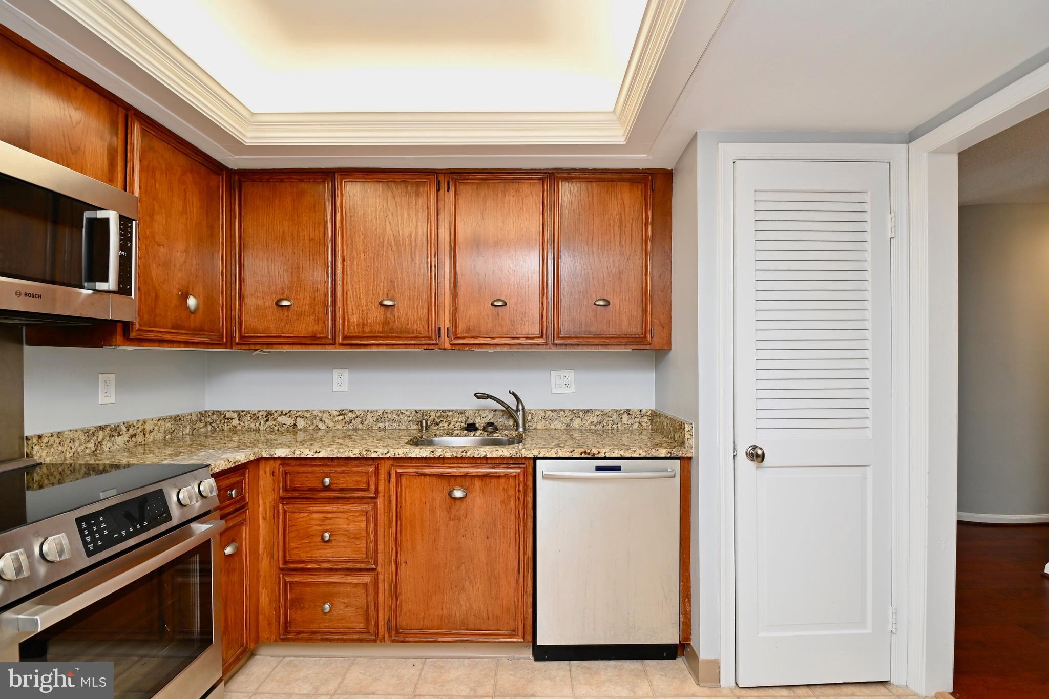 1101 South Arlington Ridge Road, Unit 509 Arlington, VA 22202 - Photo 21 of 62 a kitchen with stainless steel appliances granite countertop a stove a sink and a microwave