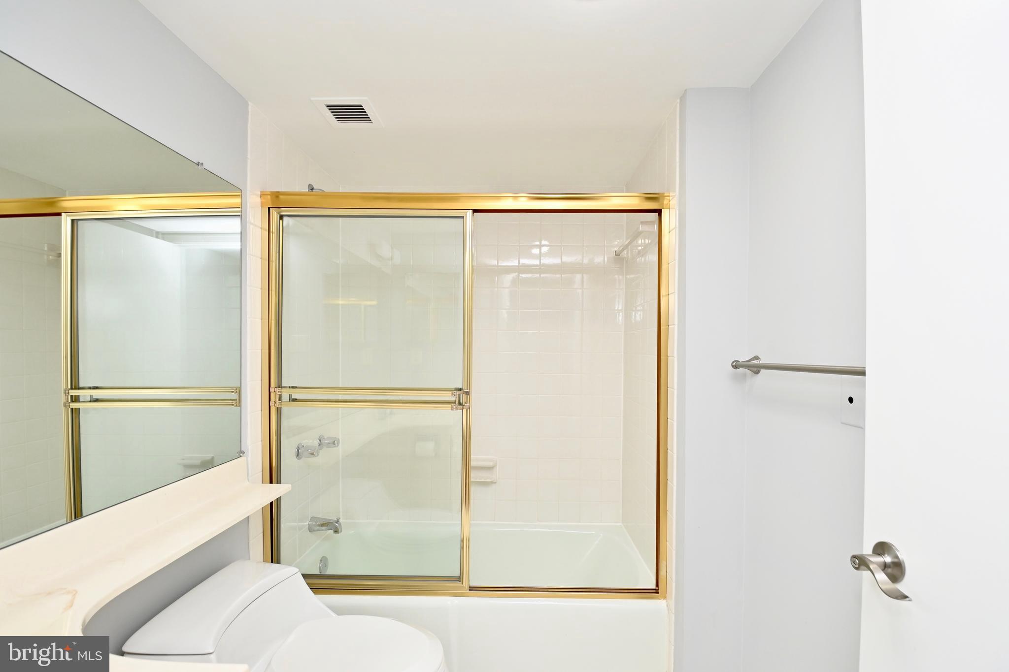 1101 South Arlington Ridge Road, Unit 509 Arlington, VA 22202 - Photo 27 of 62 a bathroom with a glass shower door