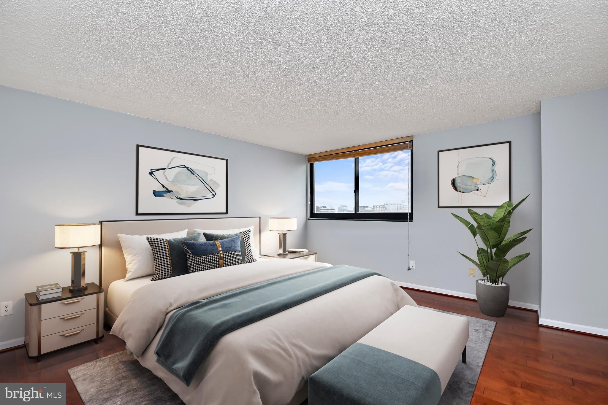 1101 South Arlington Ridge Road, Unit 509 Arlington, VA 22202 - Photo 29 of 62 a bedroom with a bed and a painting on the wall