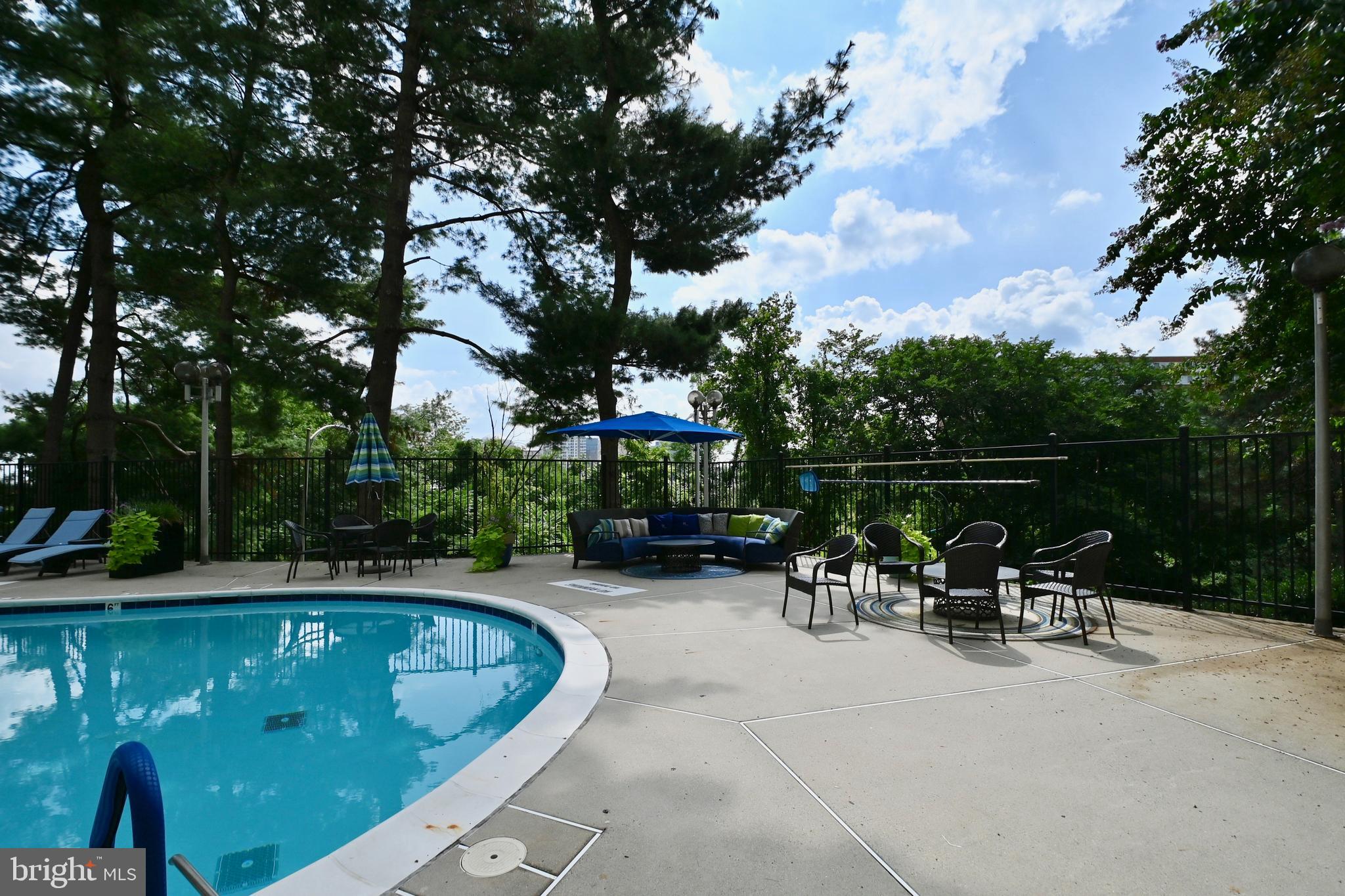 1101 South Arlington Ridge Road, Unit 509 Arlington, VA 22202 - Photo 52 of 62 a view of a swimming pool and chairs in the patio