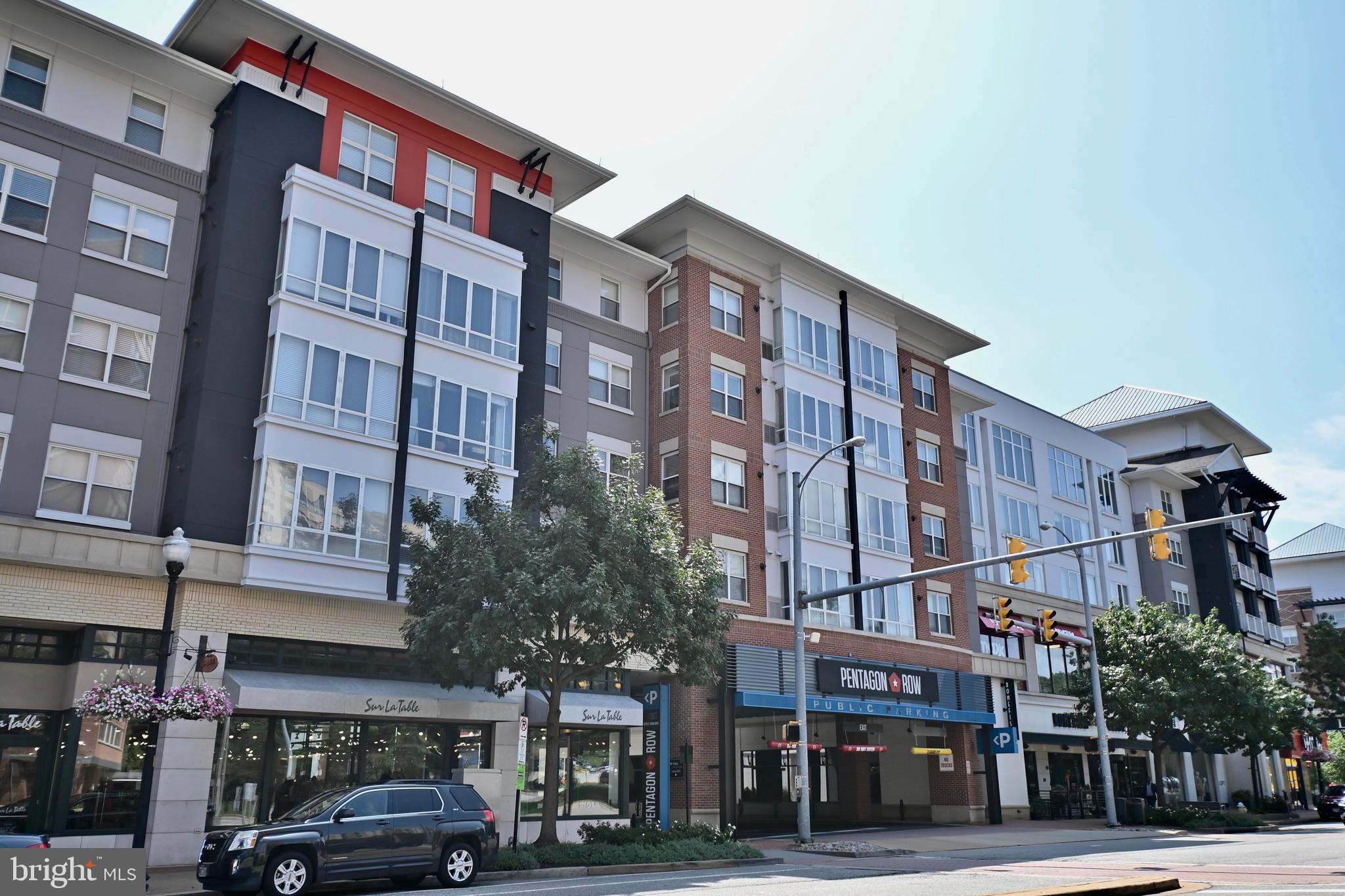 1101 South Arlington Ridge Road, Unit 509 Arlington, VA 22202 - Photo 58 of 62 a front view of a building with lot of cars and trees