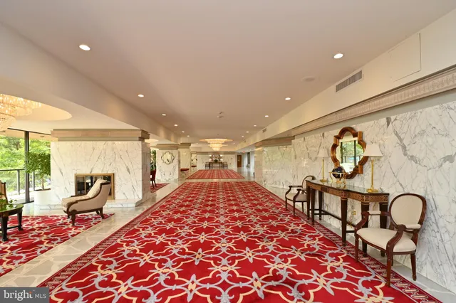 an empty room with wooden floor chandelier fan and closet area
