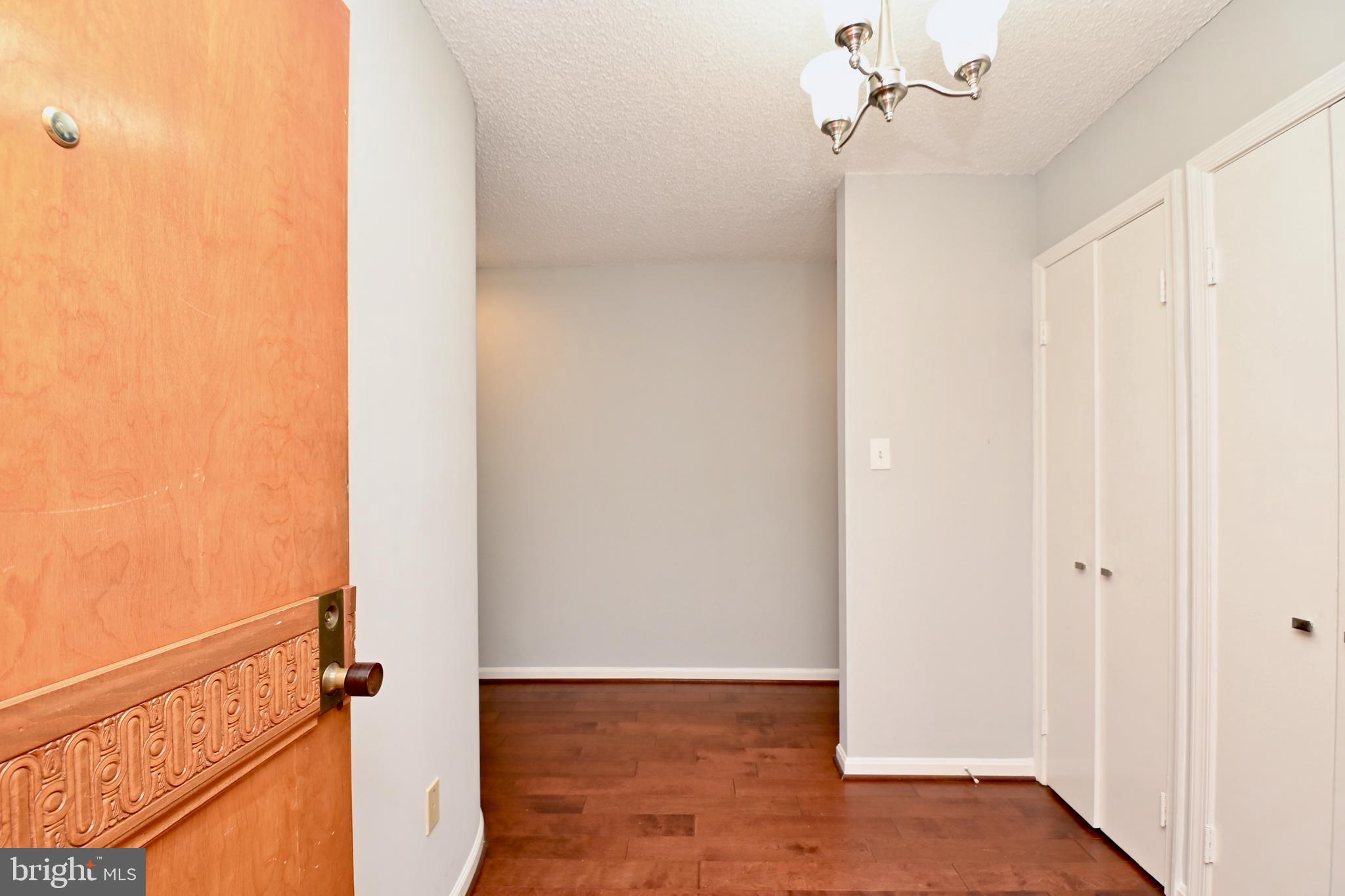 1101 South Arlington Ridge Road, Unit 509 Arlington, VA 22202 - Photo 10 of 62 a view of a hallway with wooden floor and staircase