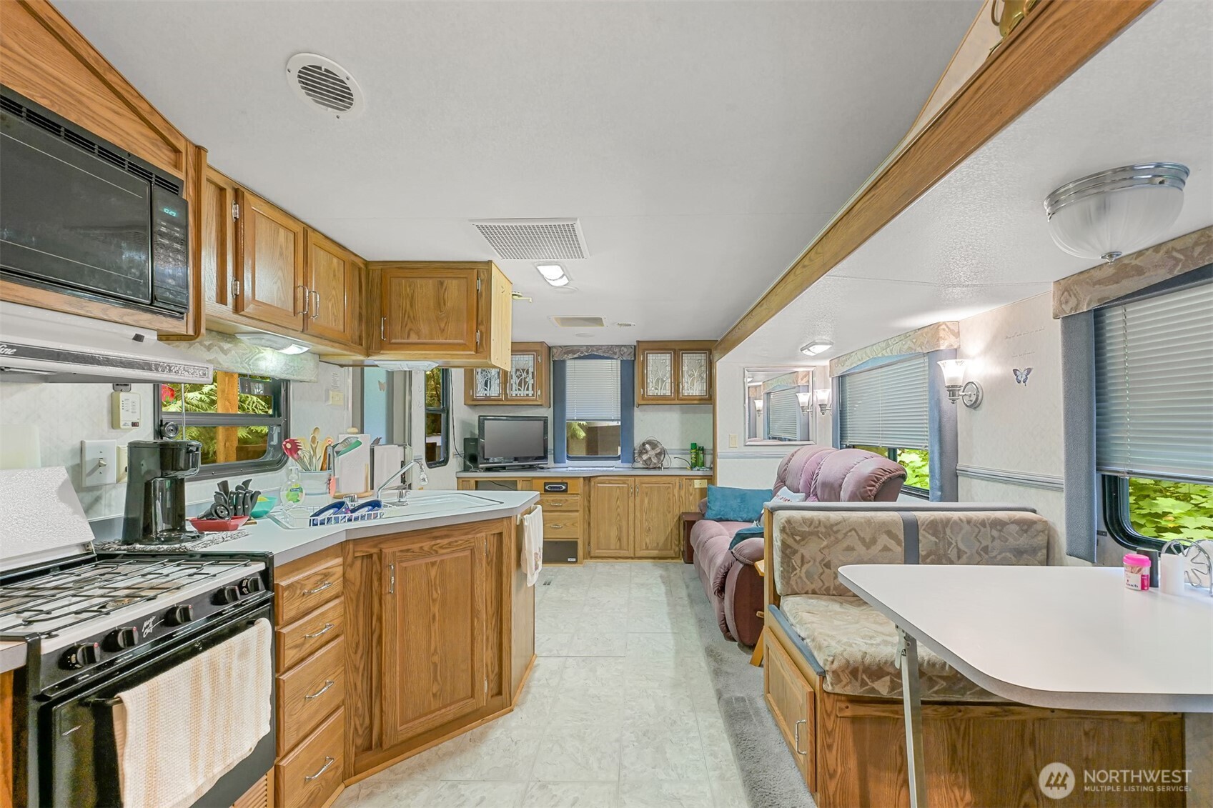 a kitchen with counter top space and stainless steel appliances