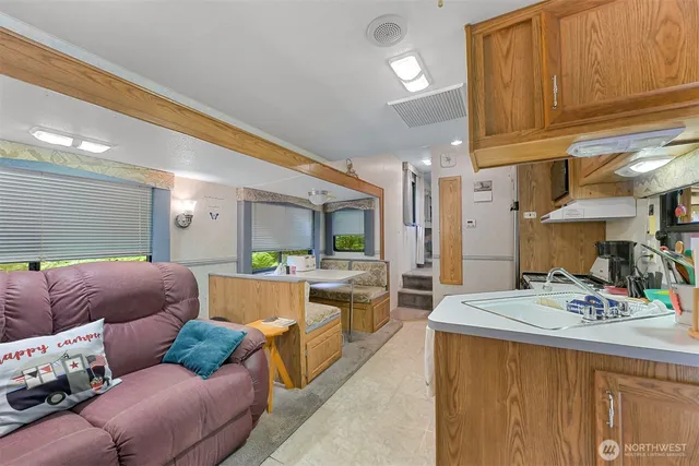 a living room with furniture and a kitchen