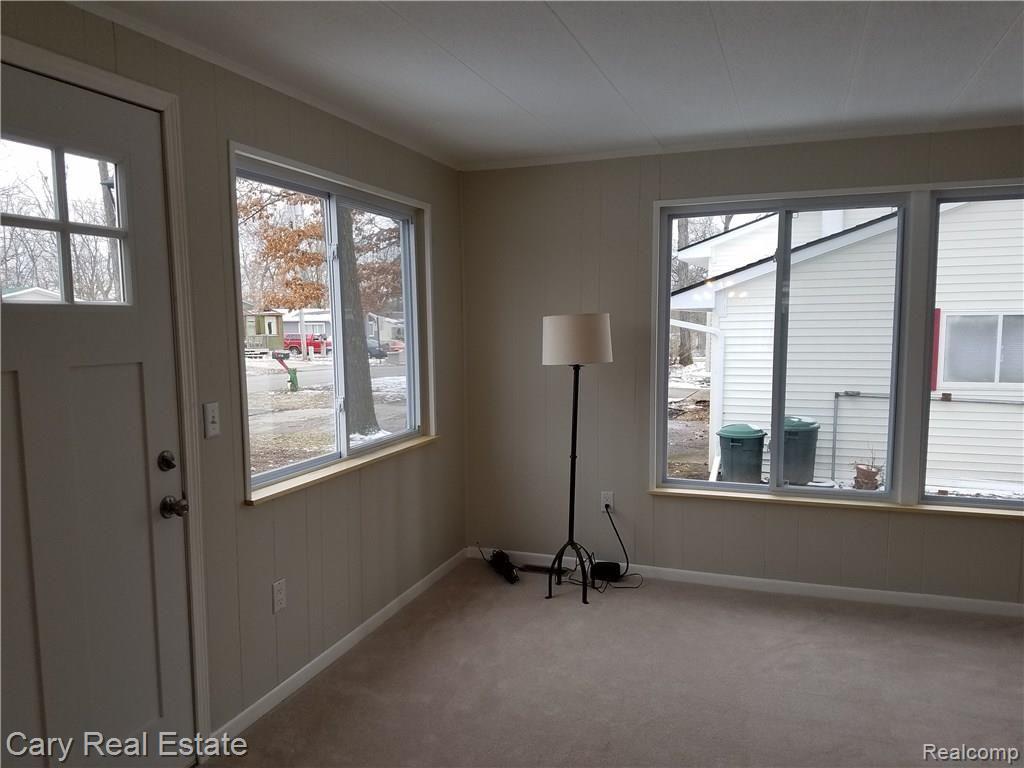 636 West Baker Road Highland, MI 48357 - Photo 9 of 22 Bright Living room with brand new windows