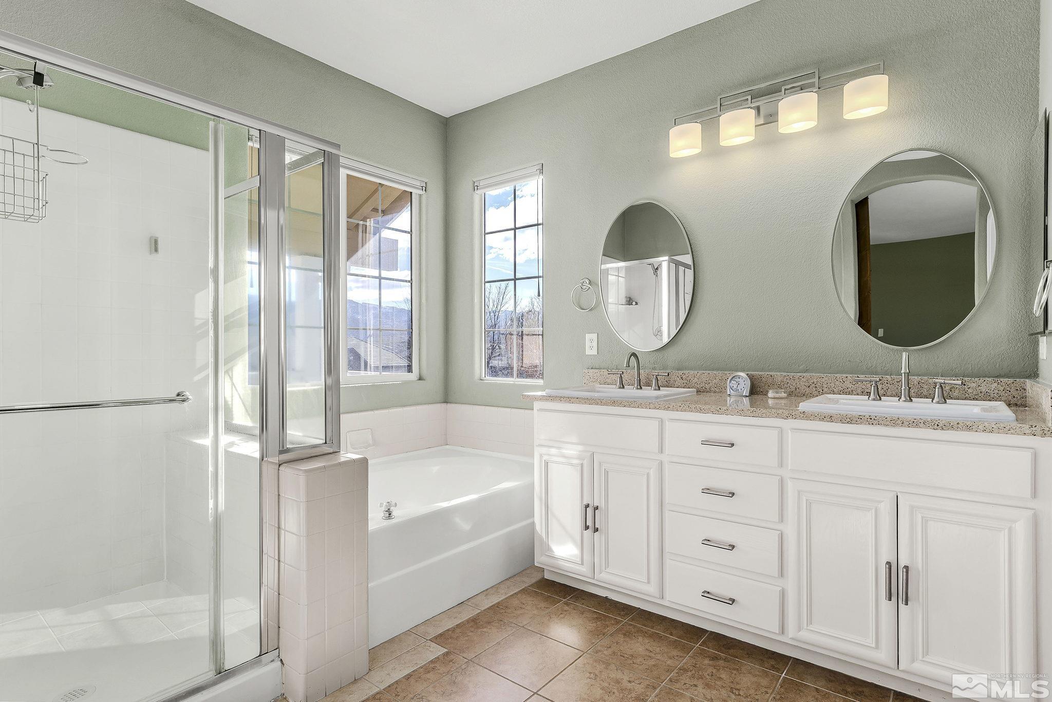 10525 Yuba Court Reno, NV 89521 - Photo 11 of 13 a bathroom with a double vanity sink mirror and bathtub