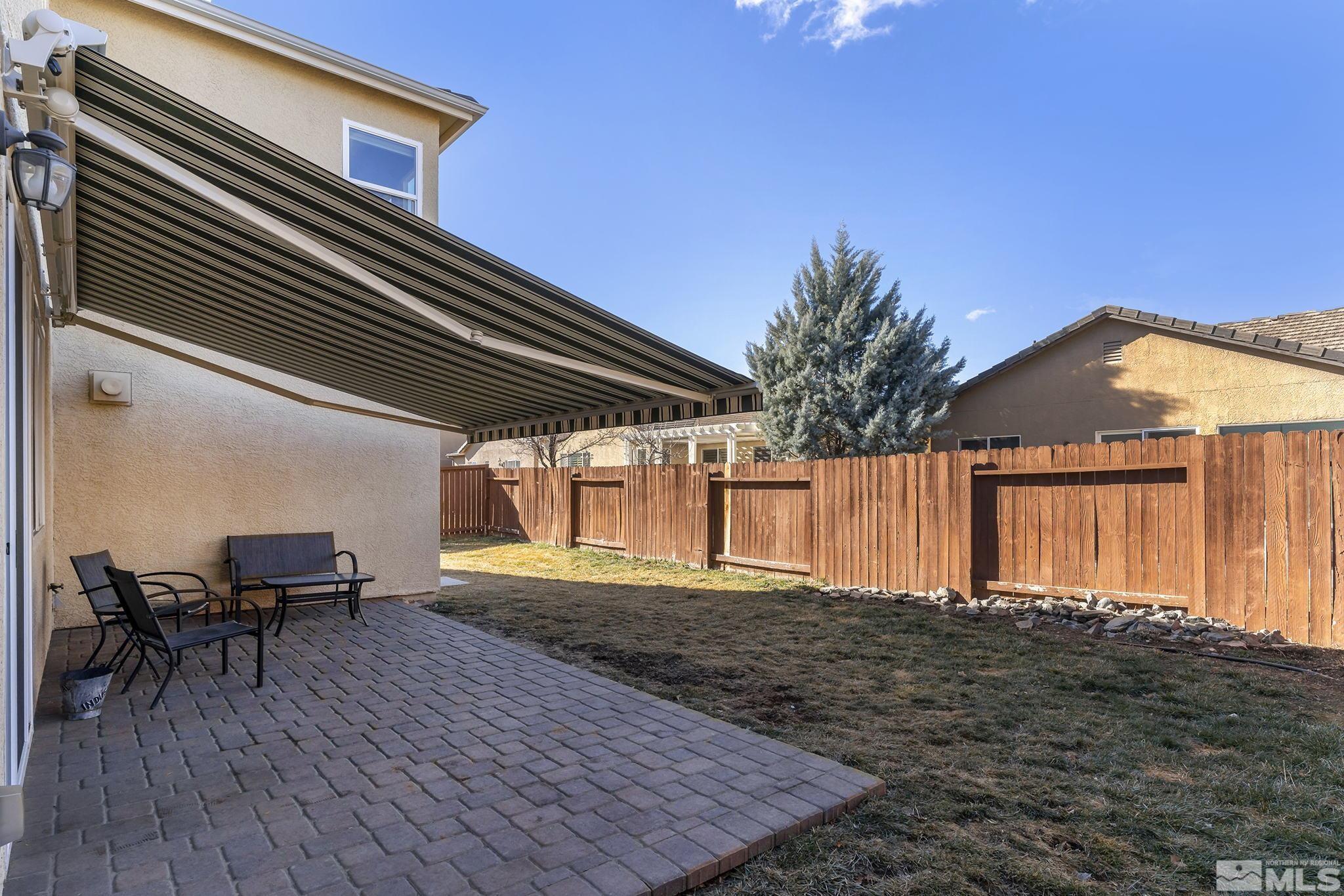 10525 Yuba Court Reno, NV 89521 - Photo 13 of 13 a backyard of a house with table and chairs