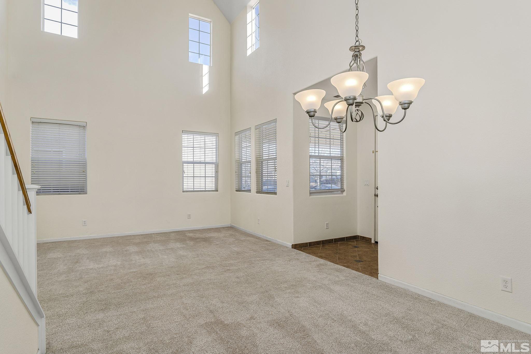10525 Yuba Court Reno, NV 89521 - Photo 3 of 13 a view of an empty room with chandelier fan