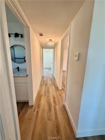 an empty room with wooden floor and window