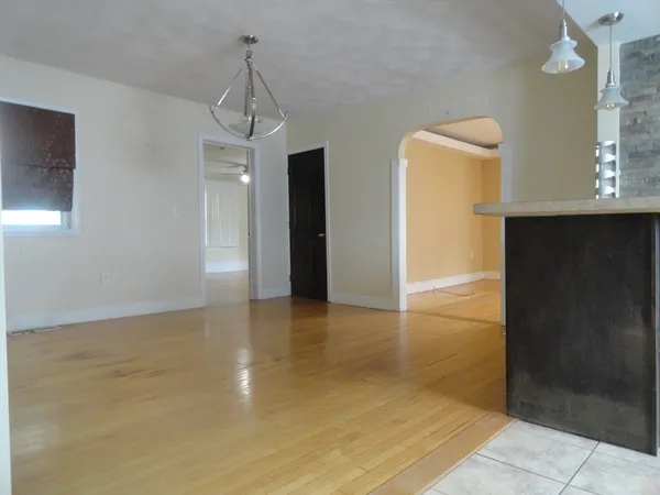 a view of a room with wooden floor and cabinet