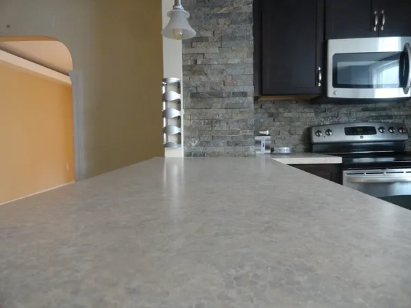 a kitchen with stainless steel appliances a sink a stove top oven and a counter top space