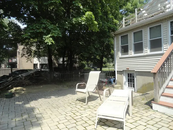 a view of backyard with a chair and tables