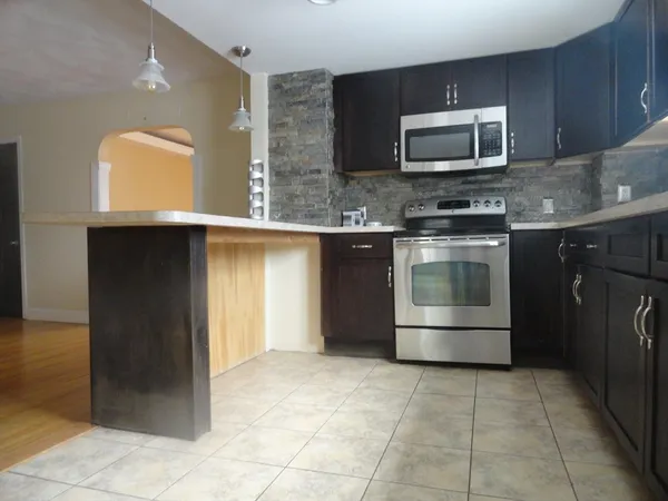 a kitchen with a stove microwave and sink