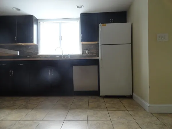a kitchen with a refrigerator and window