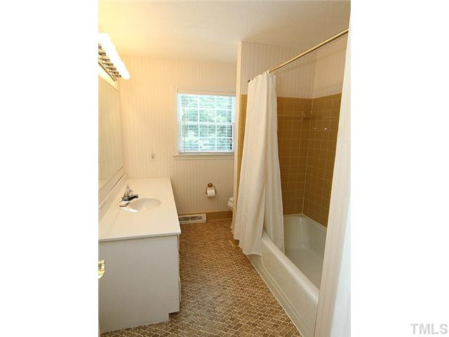 423 Oakridge Road Cary, NC 27511 - Photo 16 of 25 Tiled bathroom and large vanity in upstairs! Bathroom