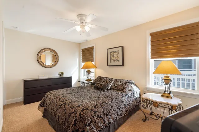 a bedroom with a bed and a lamp on table