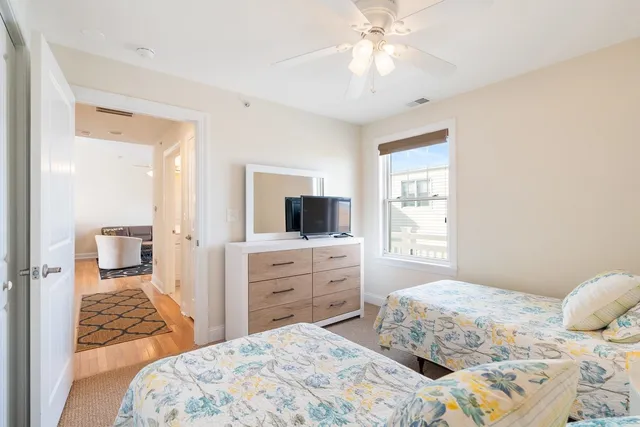 a bedroom with a large bed and a chandelier