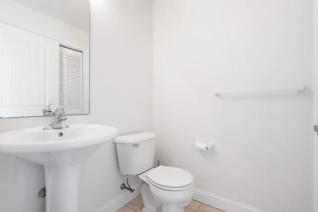 a bathroom with a sink a toilet and mirror