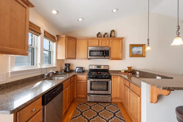 a kitchen with a sink stove and microwave