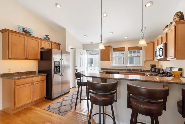 a kitchen with refrigerator cabinets dining table and chairs