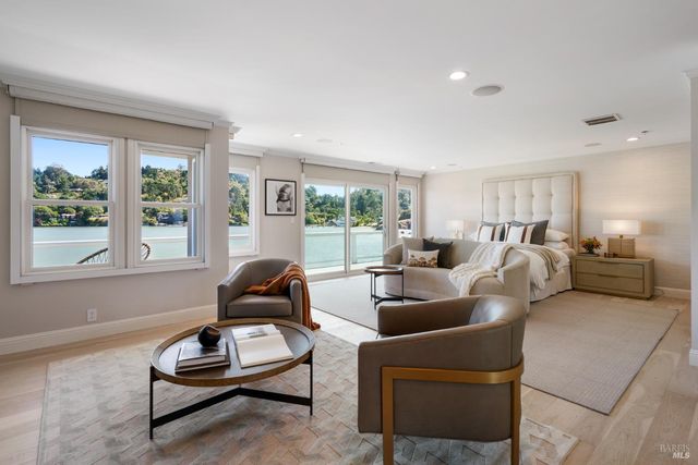 a living room with furniture a window and a lamp