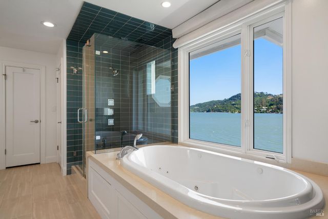 a white bath tub sitting next to a shower