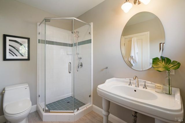 a bathroom with a sink toilet and shower
