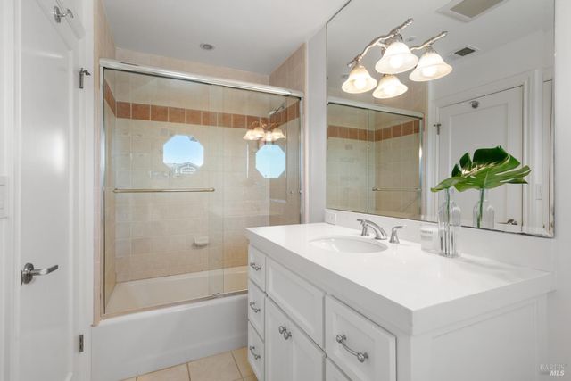 a bathroom with a sink a mirror and a shower