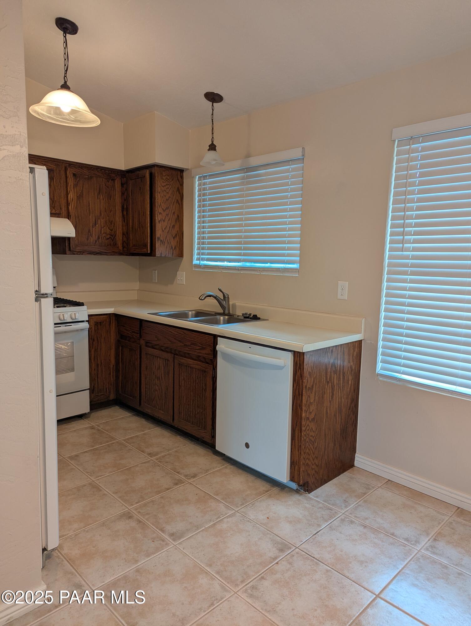 345 South Virginia Street, Unit 1 Prescott, AZ 86303 - Photo 13 of 13 a kitchen with stainless steel appliances granite countertop a sink and a stove