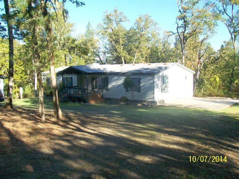 898 Greenview Road Cave Junction, OR 97523 - Photo 2 of 23 a view of a house with a yard